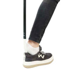 Skohorn a person's leg and a stick in a shoe