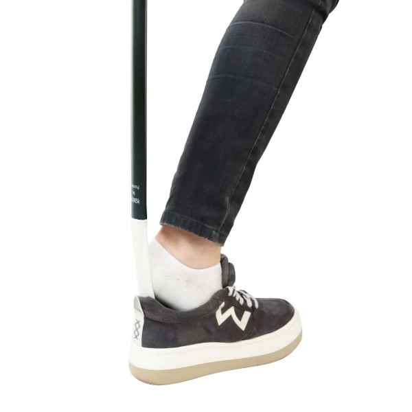 Skohorn a person's leg and a stick in a shoe