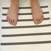 a person's feet on a white surface