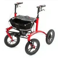 Rollator Walker 12er Trionic. Red Trionic Walker 12er rollator with large air-filled wheels and black basket for outdoor use
