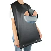 Person holding up black adult bib with buttoned spill pocket
