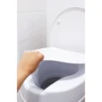 a hand reaching out to open a toilet