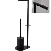 Freestanding toilet paper and brush holder in black matte metal for floor placement in bathrooms.