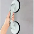 a hand holding a suction cup