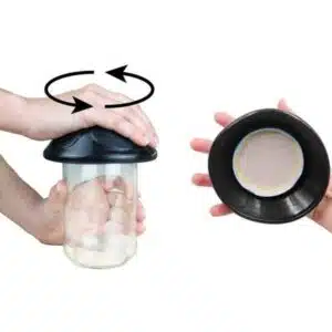 a hand holding a glass container
