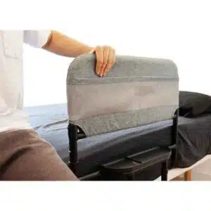 a person holding a grey and black bed