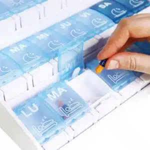 a hand holding a pill capsule