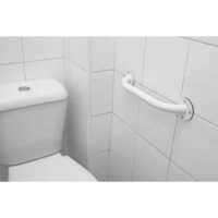 White safety bar mounted on toilet in bathroom
