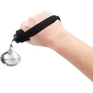 Spoon with black Velcro handle attached to one hand - adapted for people with limited mobility.