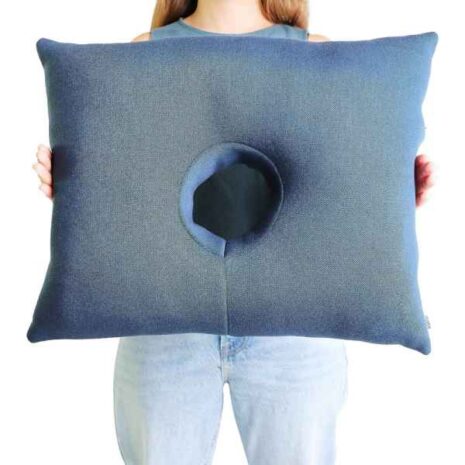 blob-4-62.jpg a person holding a pillow with a hole in the center