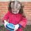 a young girl holding a blue frisbee