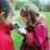 a young girl holding a cell phone