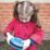 a young girl holding a blue frisbee
