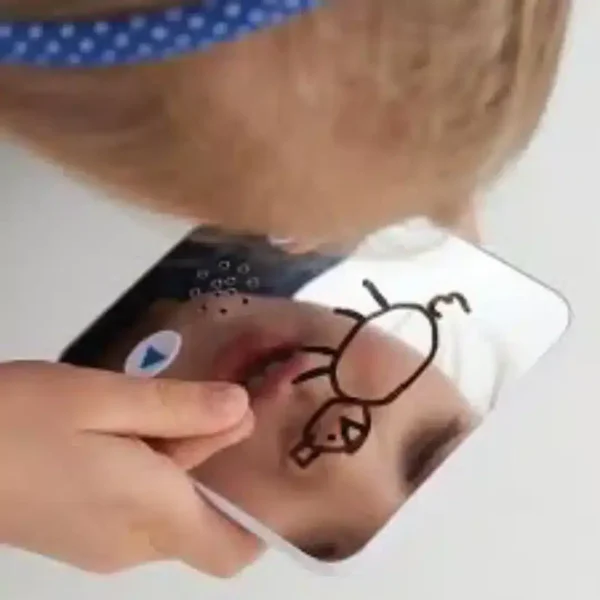 a child drawing on a mirror