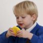 a young boy holding a yellow object