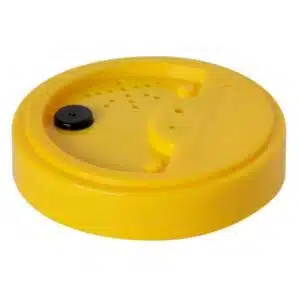 a yellow plastic object with a black circle