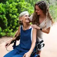 Rollator and wheelchair in one used outdoors – blue model in operation
