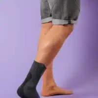 Malleo Action ankle support shown from the side - standing upright against a purple background