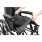 a person holding a black bag on a wheelchair
