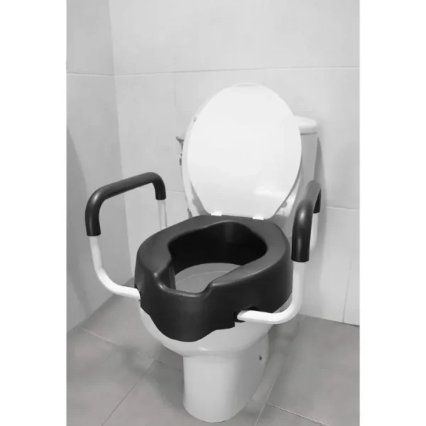 Toilet seat raiser installed in bathroom with tiled wall